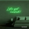 Let's Get Naked neon sign in green for bathroom decor, cheeky bedrooms, and romantic lighting.