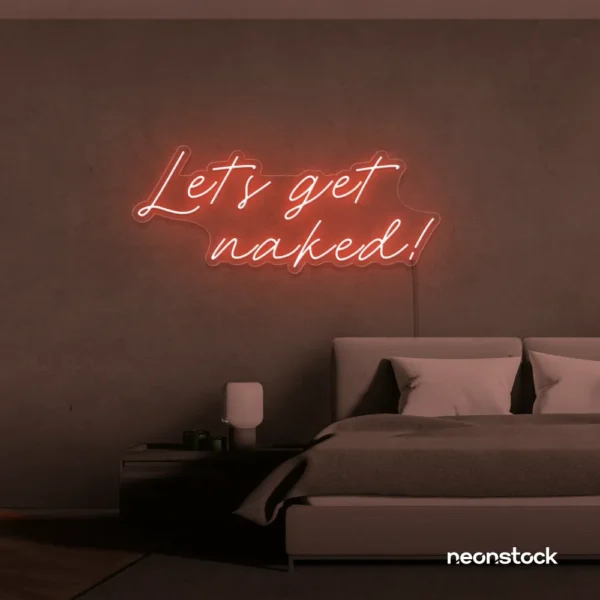 Let's Get Naked neon sign in peachy pink for bathroom decor, cheeky bedrooms, and romantic lighting.