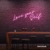 Love Yourself neon sign in baby pink for self-love decor, beauty rooms, and empowering spaces.