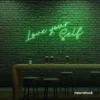 Love Yourself neon sign in green for self-love decor, beauty rooms, and empowering spaces.