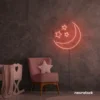 Moon and star neon sign in peachy pink for nurseries, kids' rooms, and dreamy night light decor.