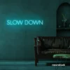 Slow Down neon sign in mint green for relaxation spaces, wellness decor, and mindful interiors.