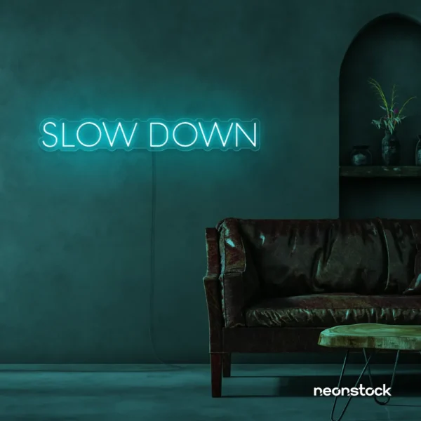 Slow Down neon sign in mint green for relaxation spaces, wellness decor, and mindful interiors.
