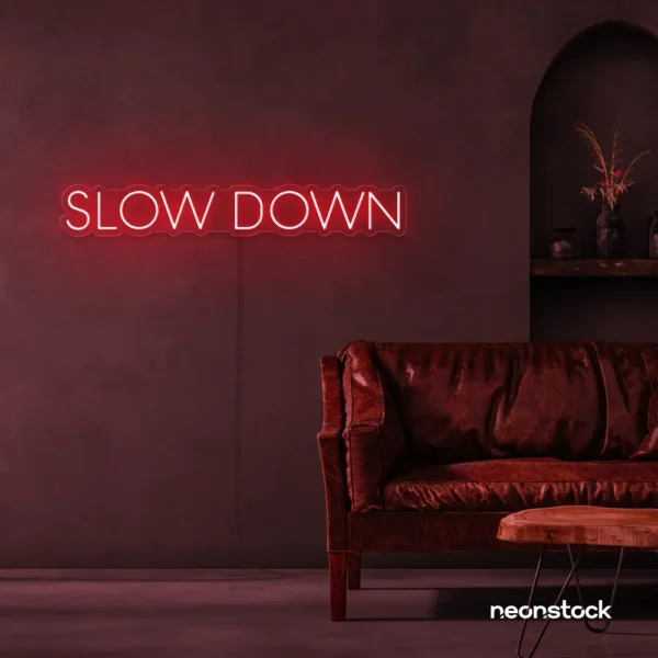 Slow Down neon sign in red for relaxation spaces, wellness decor, and mindful interiors.