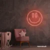 Smiley face neon sign in peachy pink for dorm walls, teen rooms, and joyful room decor.