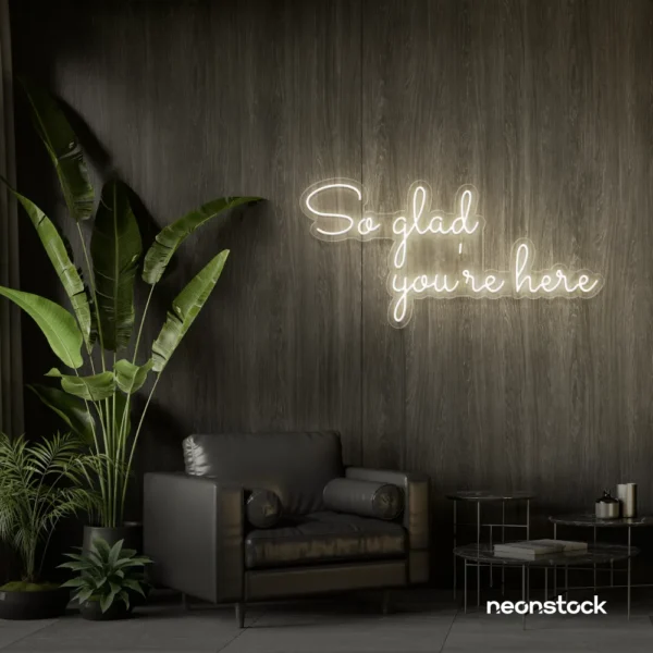 So Glad You Are Here neon sign in neutral white for entryways, restaurant walls, and welcoming interiors.