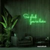 So Glad You Are Here neon sign in green for entryways, restaurant walls, and welcoming interiors.