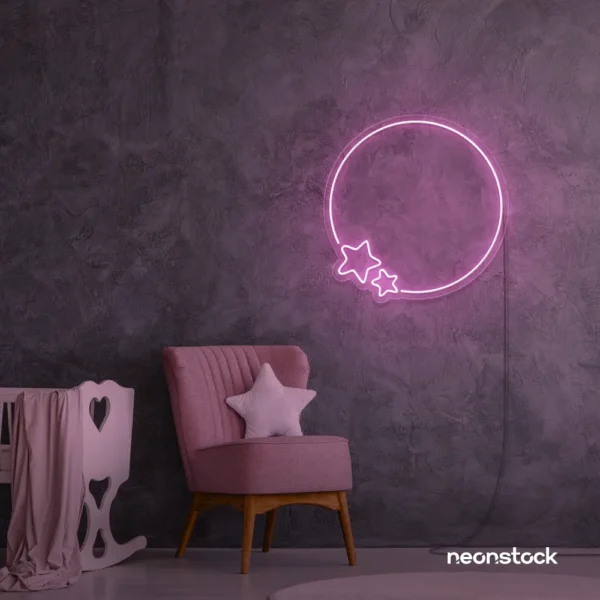 Baby pink neon sign featuring a circle and stars, glowing softly in a cozy bedroom setting.