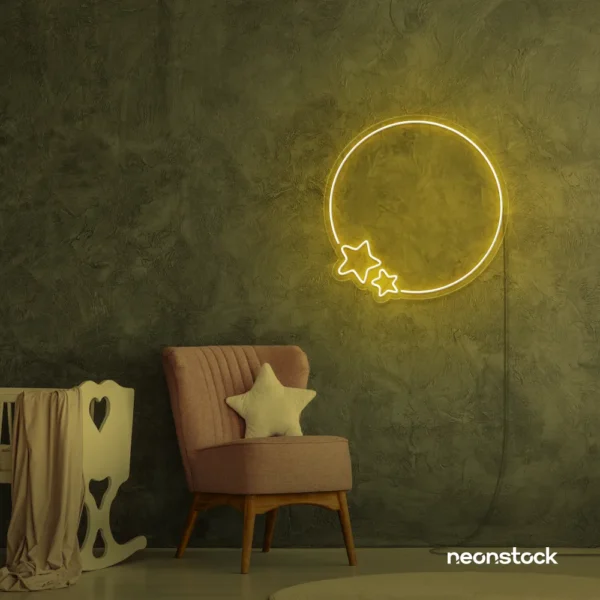 Golden yellow neon sign with circular frame and stars, glowing on a textured wall above a pink chair.