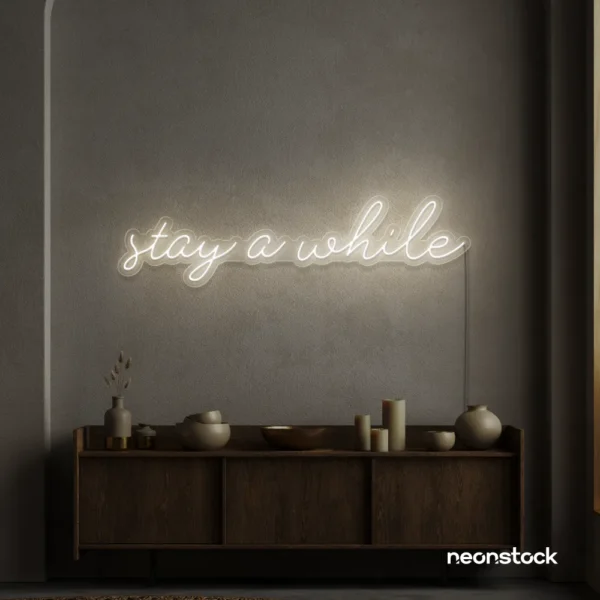 Stay Awhile neon sign in neutral white for cozy cafes, home decor, and hospitality settings.