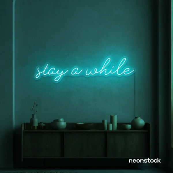 Stay Awhile neon sign in mint green for cozy cafes, home decor, and hospitality settings.