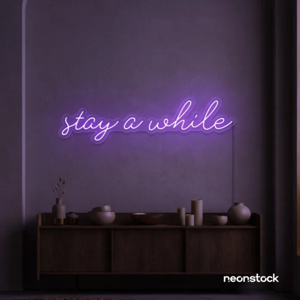Stay Awhile neon sign in purple for cozy cafes, home decor, and hospitality settings.