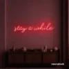 Stay Awhile neon sign in red for cozy cafes, home decor, and hospitality settings.