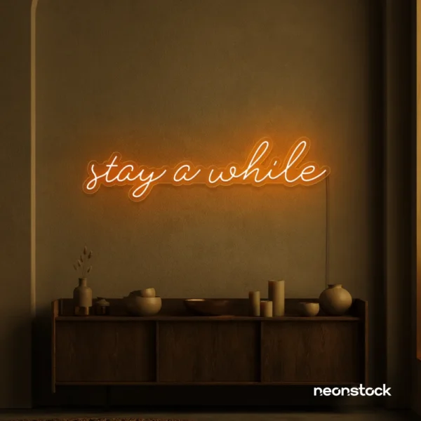 Stay Awhile neon sign in orange for cozy cafes, home decor, and hospitality settings.