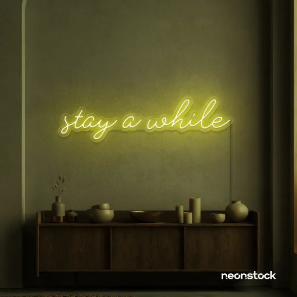 Stay Awhile neon sign in lemon yellow for cozy cafes, home decor, and hospitality settings.