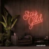 Stay Gold neon sign in peachy pink for glam rooms, babe caves, and feminine decor.