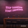 Stop Thinking Start Drinking neon sign in baby pink for bar walls, man caves, and party spaces.