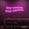 Stop Thinking Start Drinking neon sign in pink for bar walls, man caves, and party spaces.