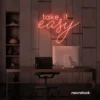 Take It Easy neon sign in peachy pink for chill wall decor, boho rooms, and relaxed interiors.