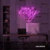 Take It Easy neon sign in pink for chill wall decor, boho rooms, and relaxed interiors.