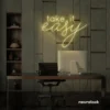 Take It Easy neon sign in warm white for chill wall decor, boho rooms, and relaxed interiors.