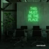 This Must Be The Place neon sign in green for cozy salons, boutique shops, and cafe decor.