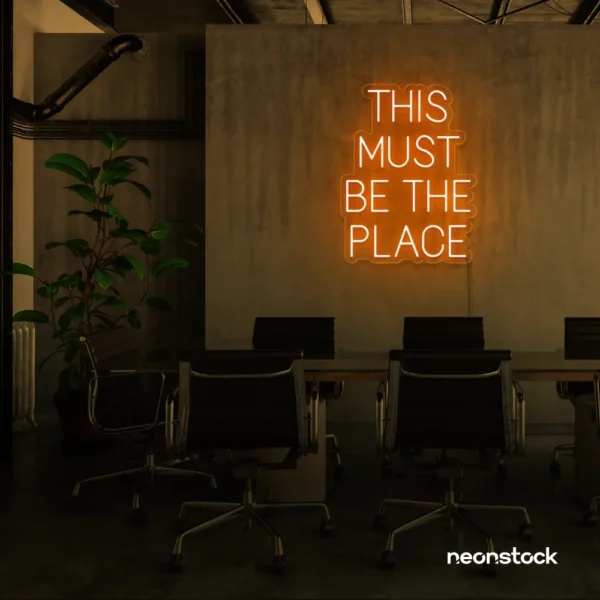 This Must Be The Place neon sign in orange for cozy salons, boutique shops, and cafe decor.