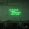 Neon sign text 'We should hang something cool here' in green for wall art and home decor