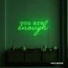 You Are Enough neon sign in deep green for self-love decor, therapy rooms, and calm spaces.