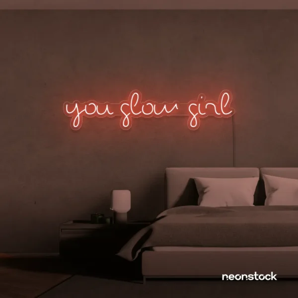 You Glow Girl neon sign in peachy pink for dorm rooms, vanity walls, and beauty studio decor.
